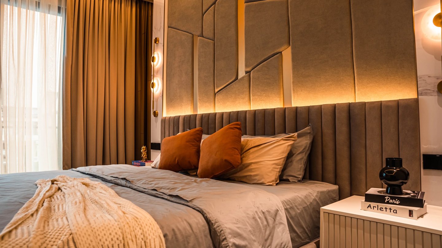 Master bedroom design in a Malaysian landed home — upholstered geometric feature wall with concealed lighting behind the bed, Setia Marina One, Cyberjaya