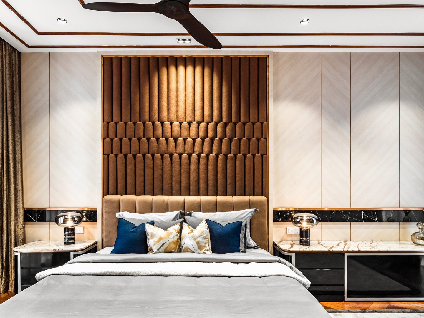 Master bedroom design with a full-height timber slat headboard wall in a Malaysian bungalow