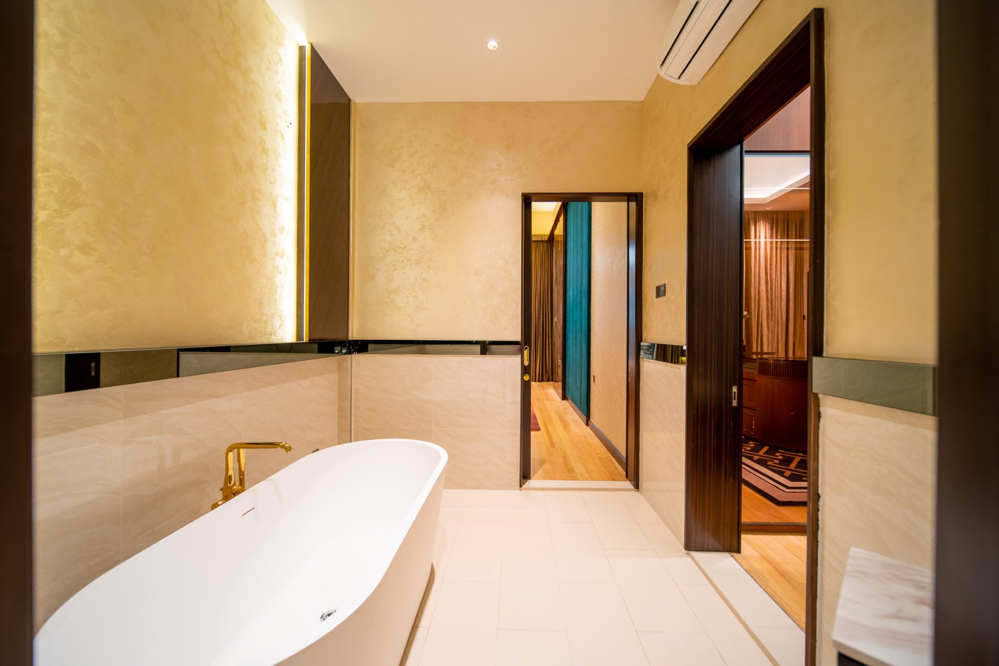 Ensuite bathroom design with the freestanding tub framed by the doorway from the bedroom, Bangsar bungalow
