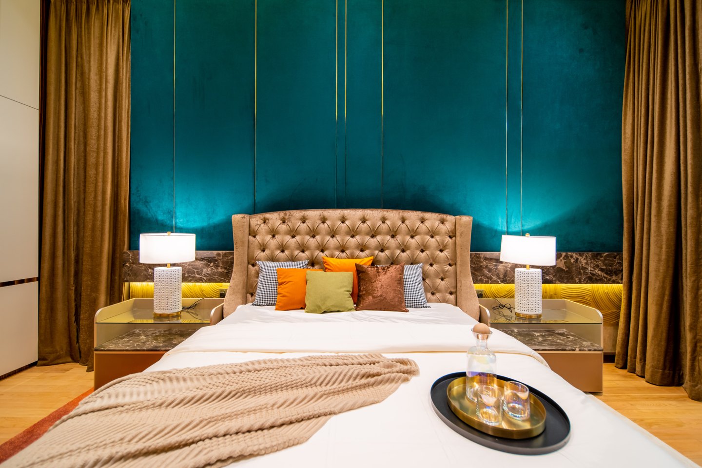 Bedroom design ideas — teal tufted headboard against gold panelling in a Bangsar bungalow bedroom