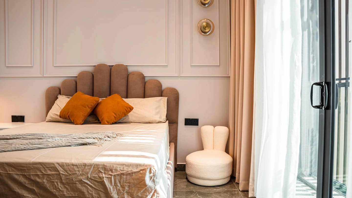 Bedroom design with a curvy scalloped upholstered headboard and boucle stool, Setia Marina One, Cyberjaya