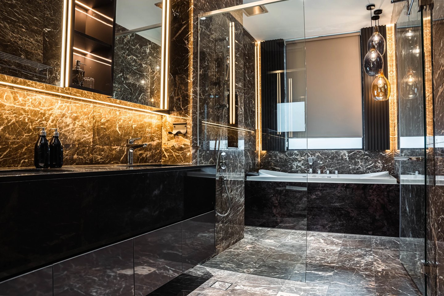Layered bathroom lighting — backlit mirror strips, pendant lights and lit stone niches over the vanity in a Cyberjaya master bathroom, Setia Marina One