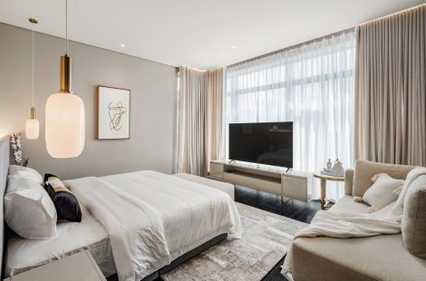 Master bedroom design with a lounge seating area and TV wall in a Kuala Lumpur condominium, Four Seasons Place