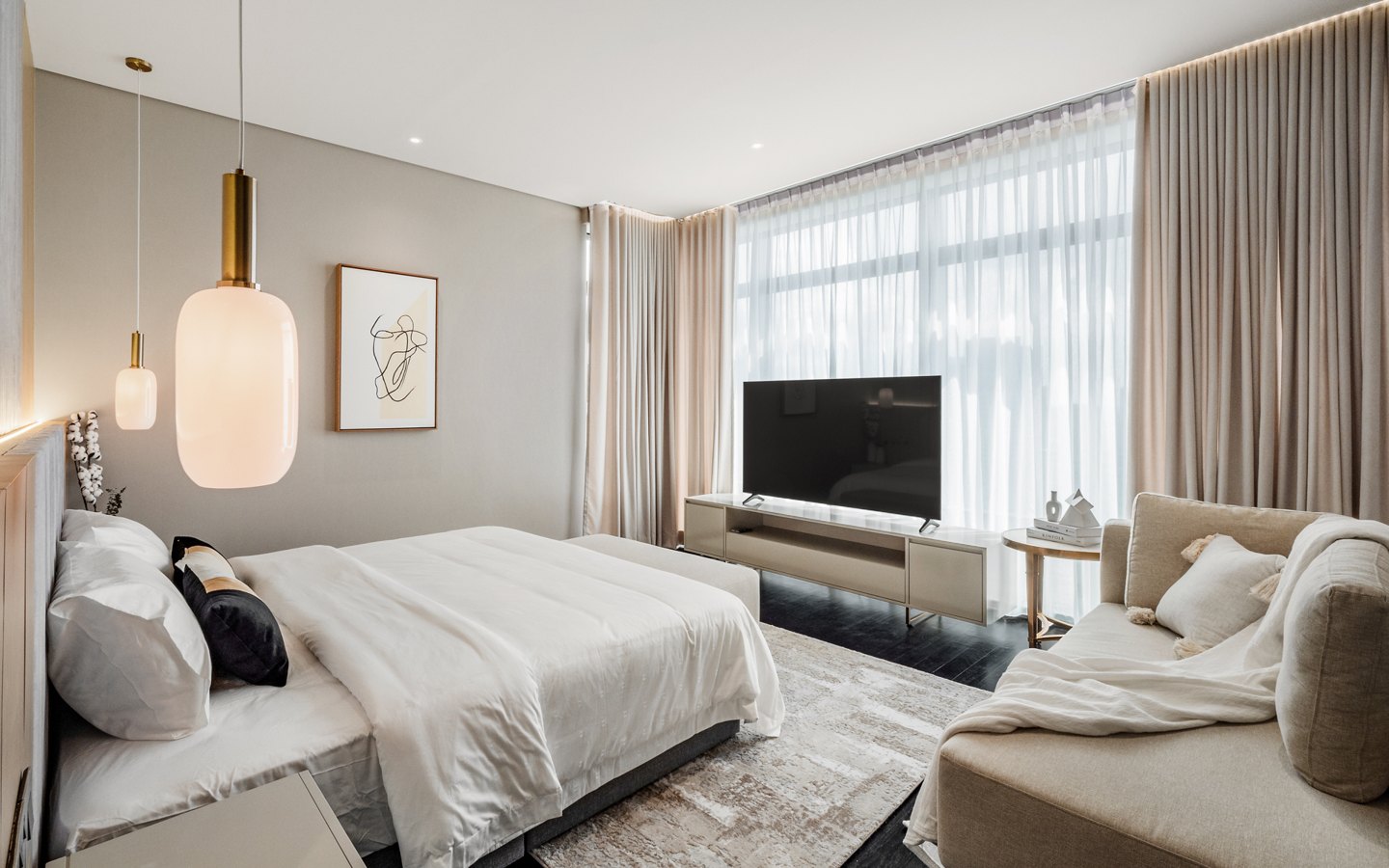Master bedroom design with a lounge seating area and TV wall in a Kuala Lumpur condominium, Four Seasons Place