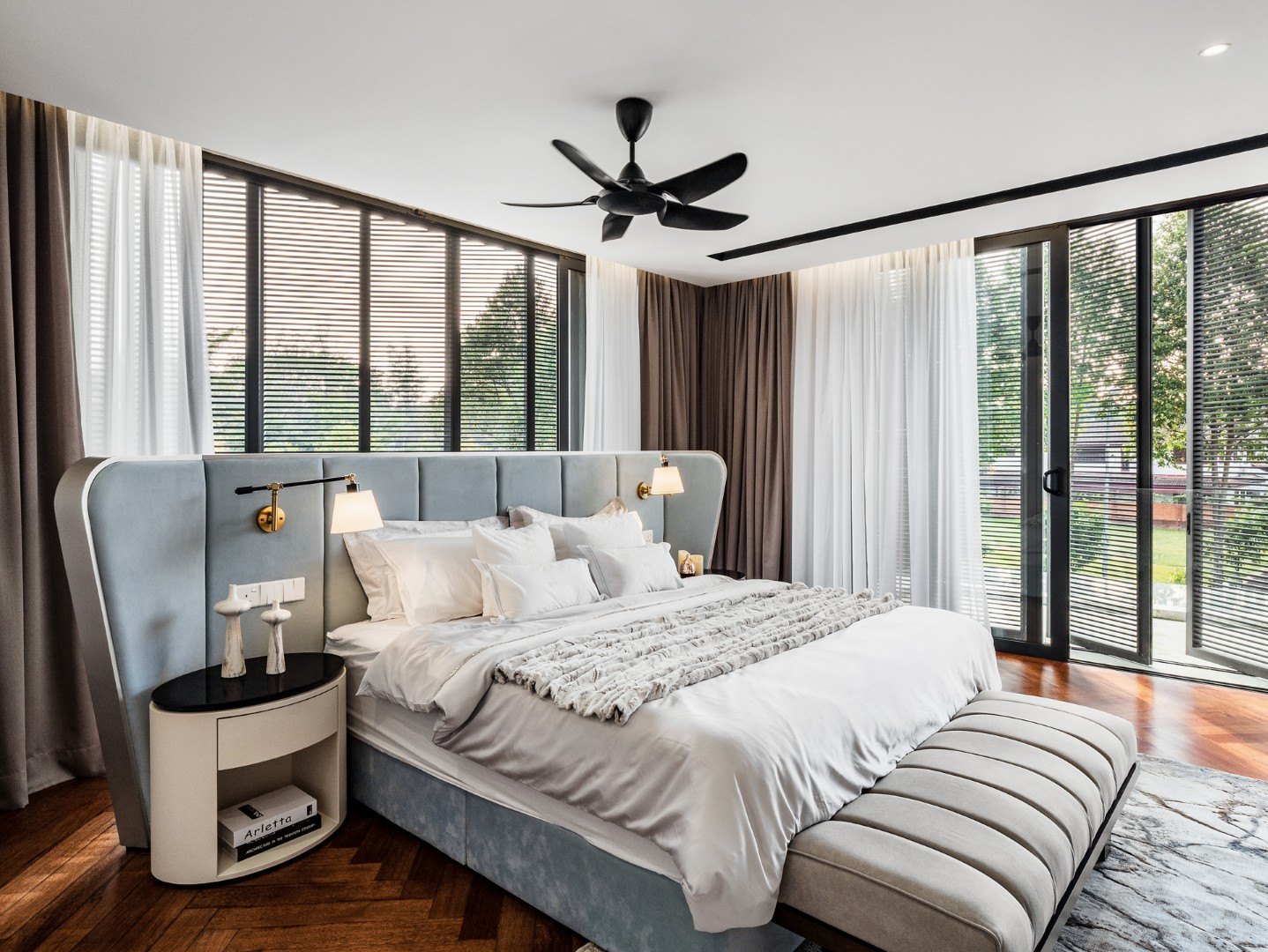 Master bedroom design in a Kelana Jaya bungalow — ceiling fan in a recessed cove, wall-to-wall curtains and an upholstered wing headboard