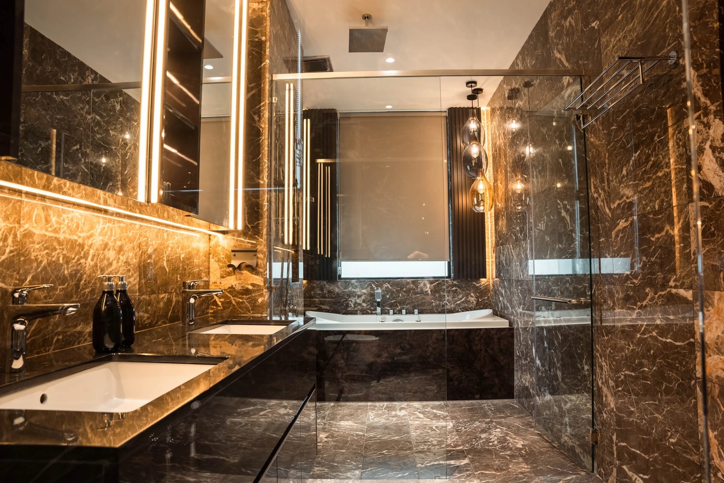 Twin basins on one marble counter under a single lit mirror in a shared master bathroom, Setia Marina One, Cyberjaya