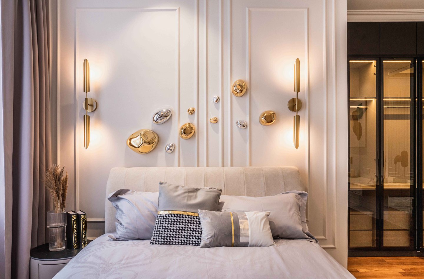Bedroom lighting ideas — wall sconces flanking the bed and a gallery wall of art above the headboard, EcoSpring