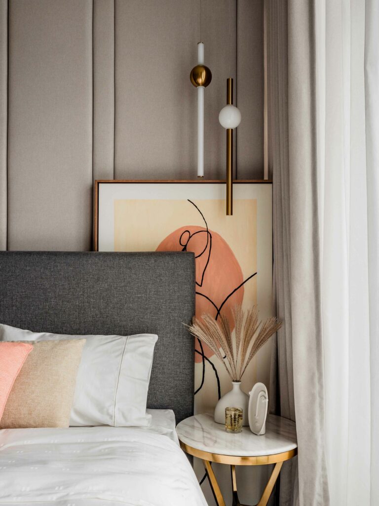 a luxury bedroom with a bed and a painting on the wall, interior designed by Blaine Robert Design