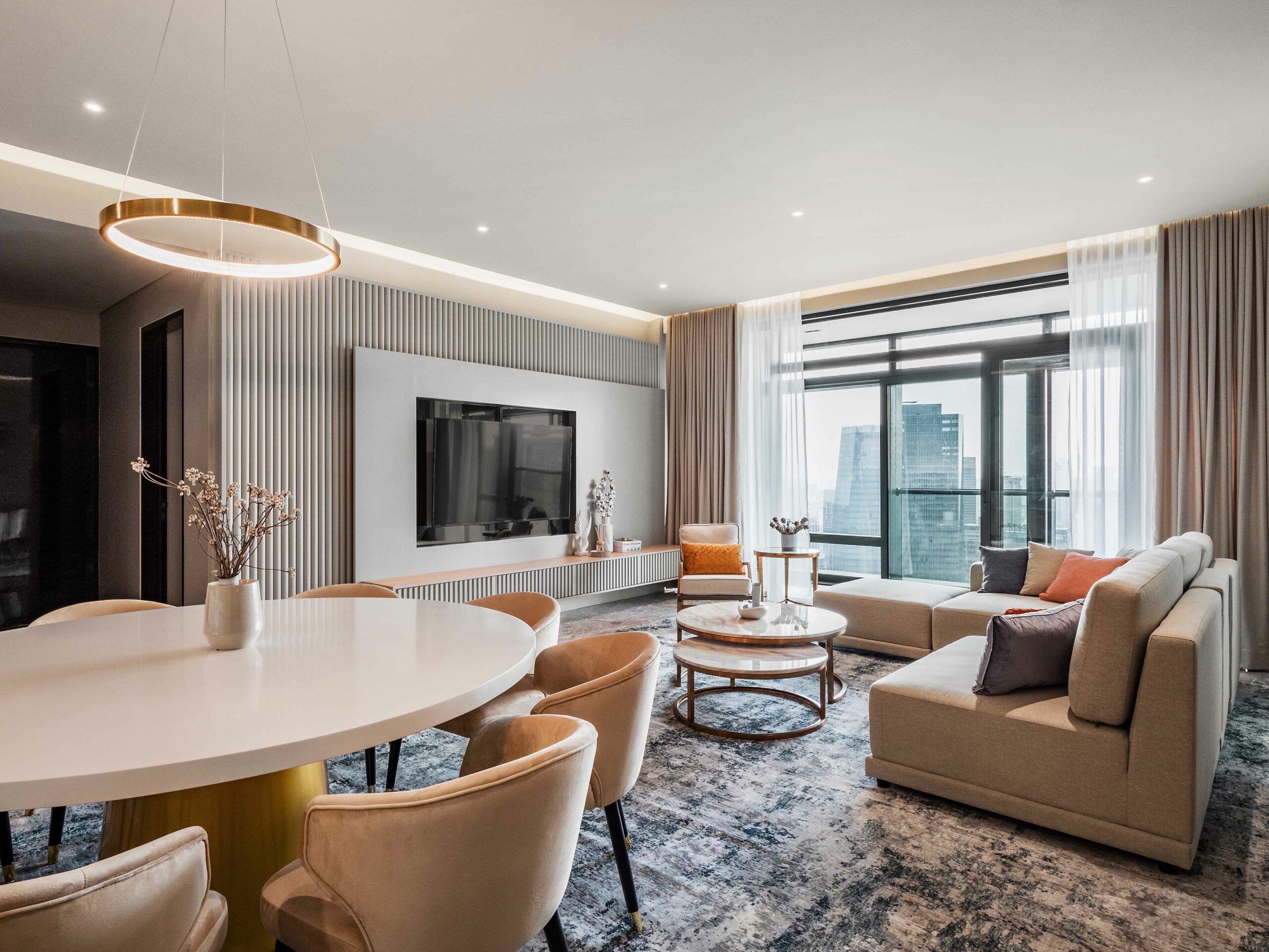 a luxury designed living room filled with exclusive custom furniture and large flat screen tv in four season residence KL, interior design by Blaine Robert Design