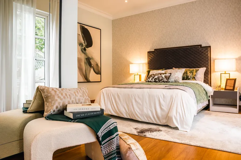 Bukit Tunku Residence, Kuala Lumpur: guest bedroom with a quilted headboard and soft-green throws
