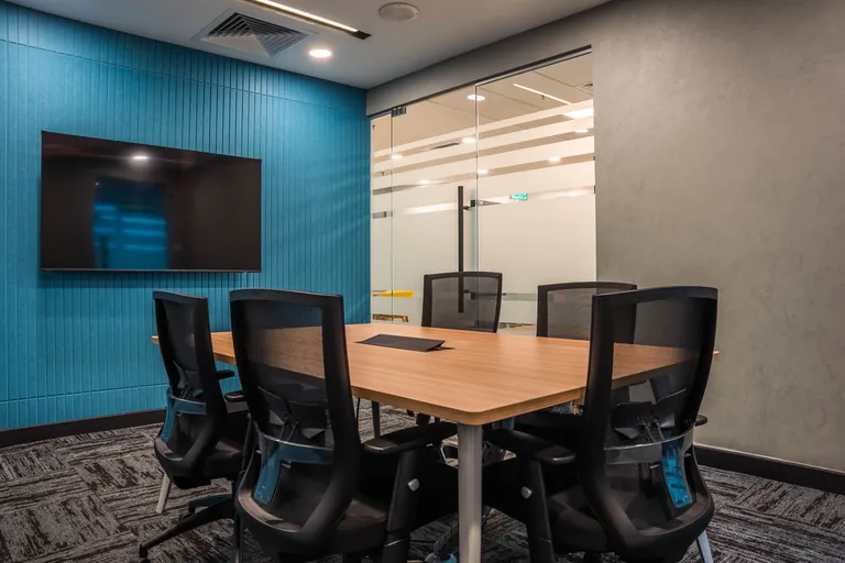 Persada PLUS Office, Petaling Jaya: meeting room with a blue acoustic wall and screen