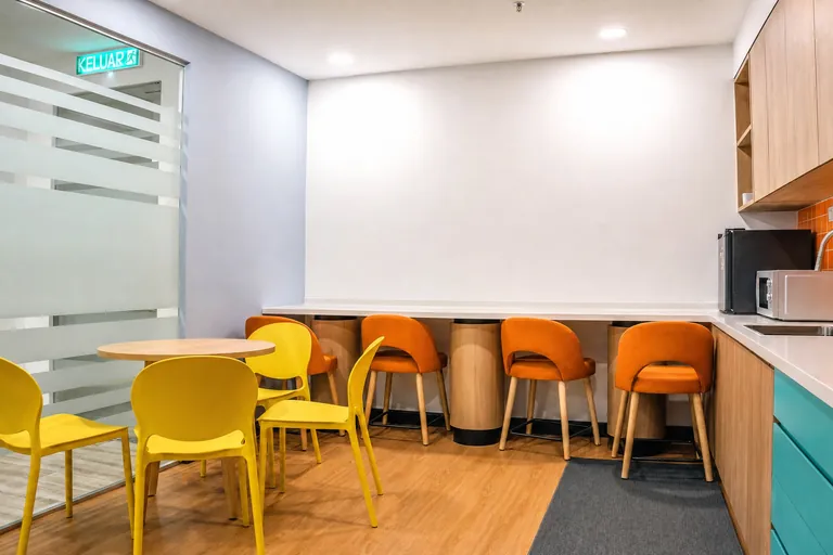 Persada PLUS Office, Petaling Jaya: pantry with yellow and orange seating