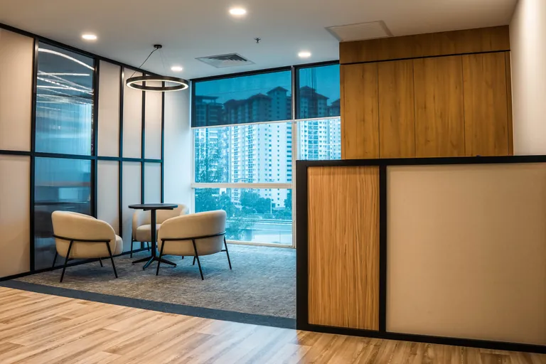 Persada PLUS Office, Petaling Jaya: lounge corner behind black-framed glass partitions