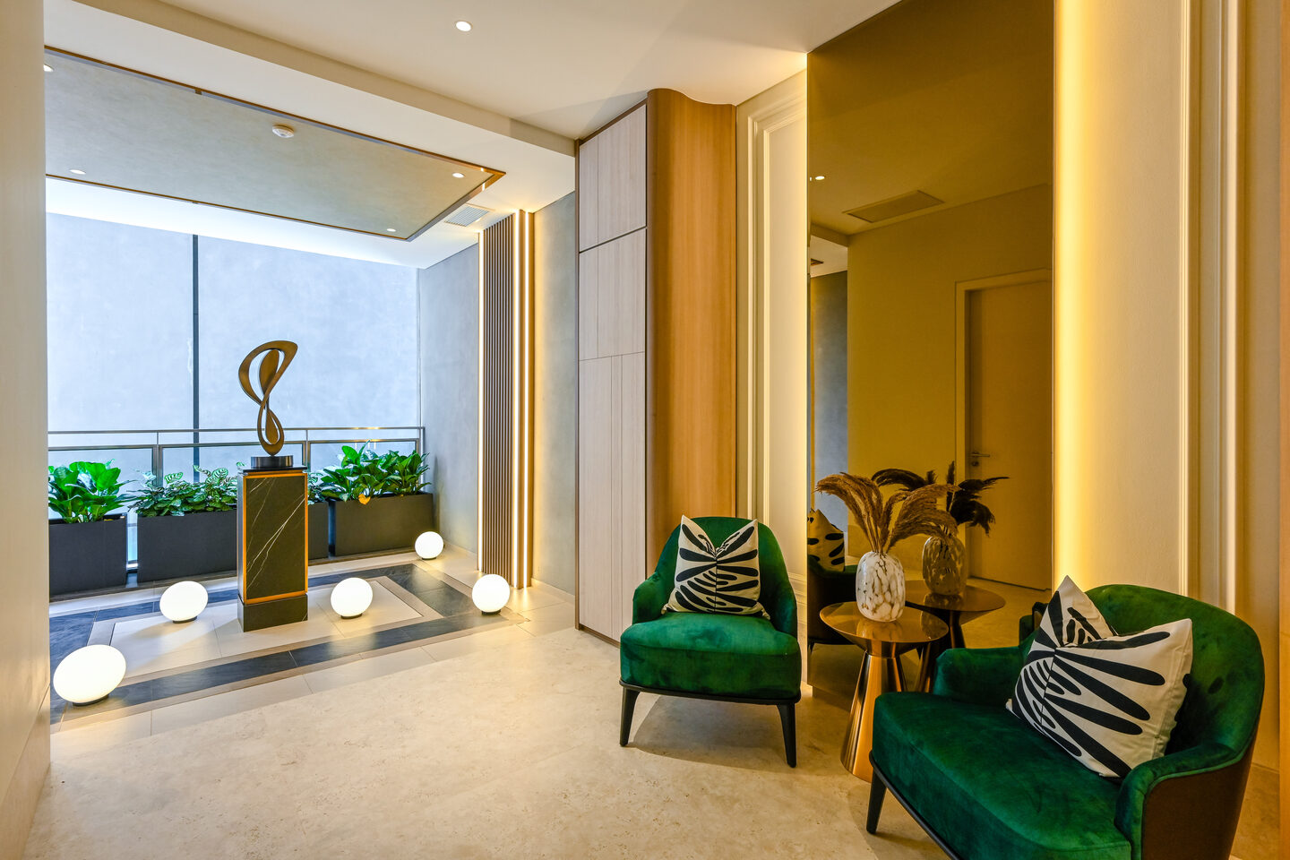 Bold green velvet armchairs against a neutral base in a KL condo interior