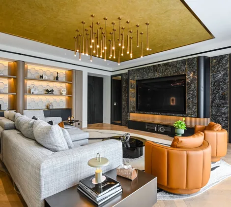 Gold-leaf tray ceiling with a cluster of linear pendants over the living room at Aira Residence, Damansara Heights, by Blaine Robert Design