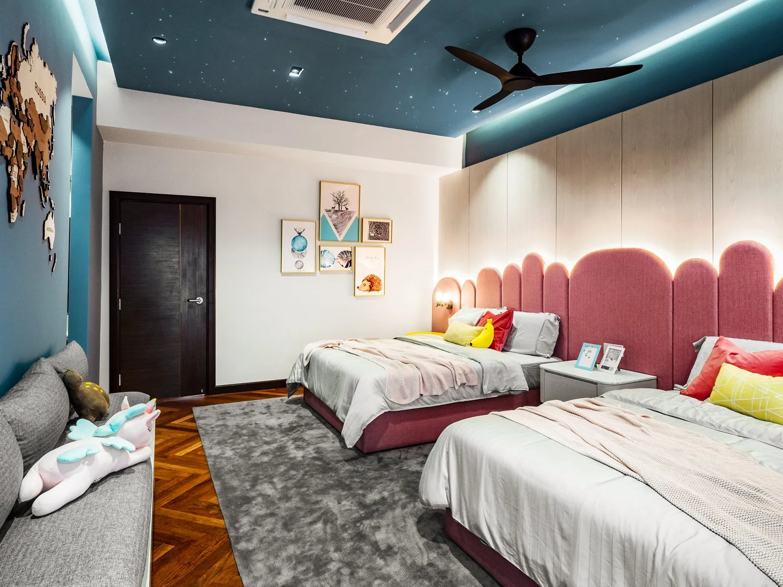 Dark teal ceiling with a ceiling fan over a children's bedroom in the Terengganu bungalow