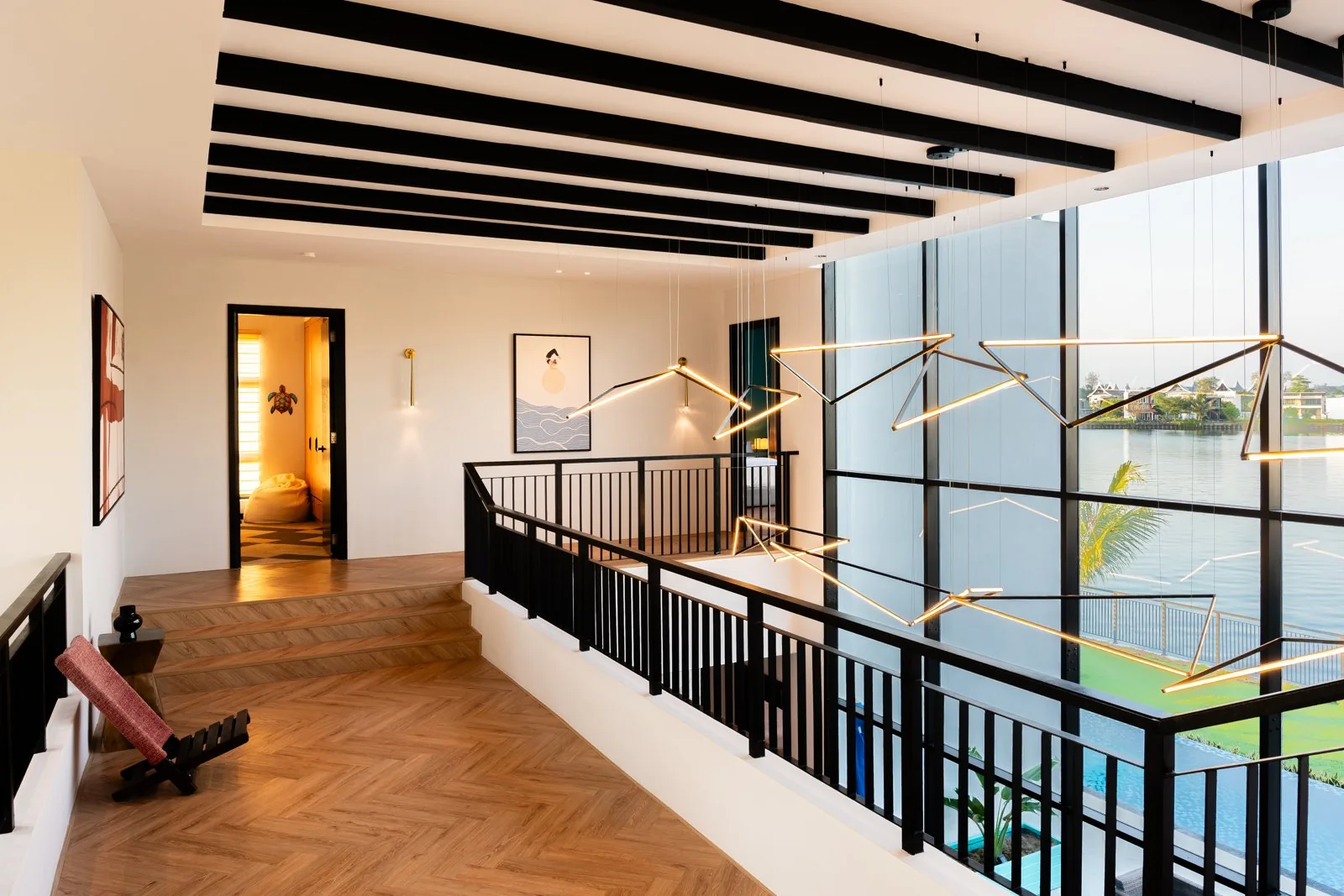 Black exposed beams across the white ceiling of the upper landing at Quayside Villa, Port Dickson
