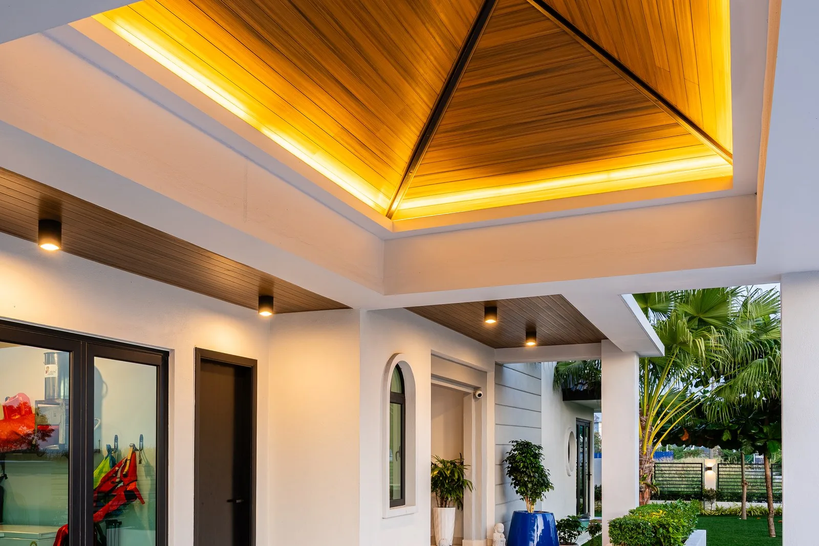 Timber-lined pyramid ceiling with cove lighting over the covered terrace at Quayside Villa, Port Dickson