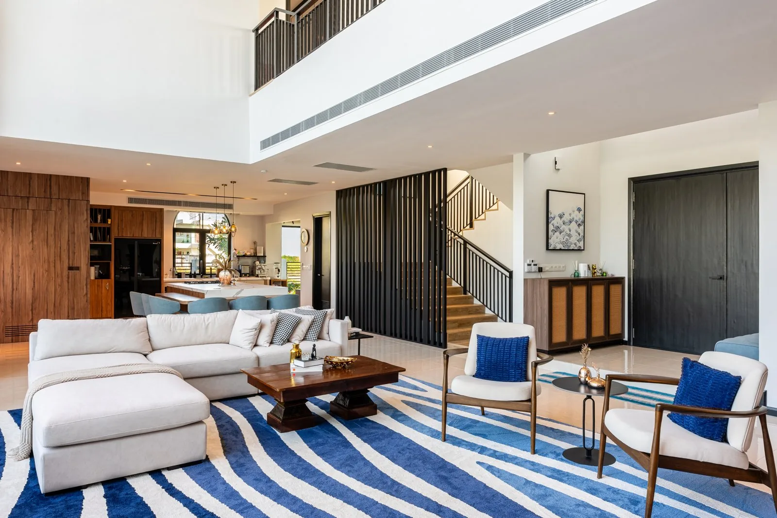 Double-height living room with a gallery above at Quayside Villa, Port Dickson