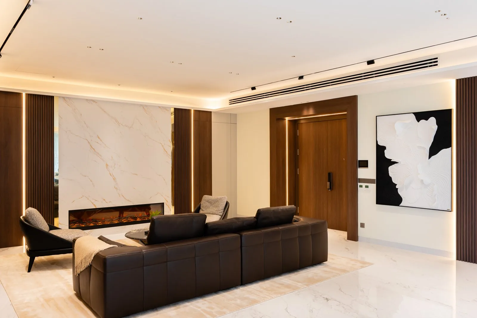 Linear track lighting and a lit cove in the living room at Park Regent Residence, Desa ParkCity