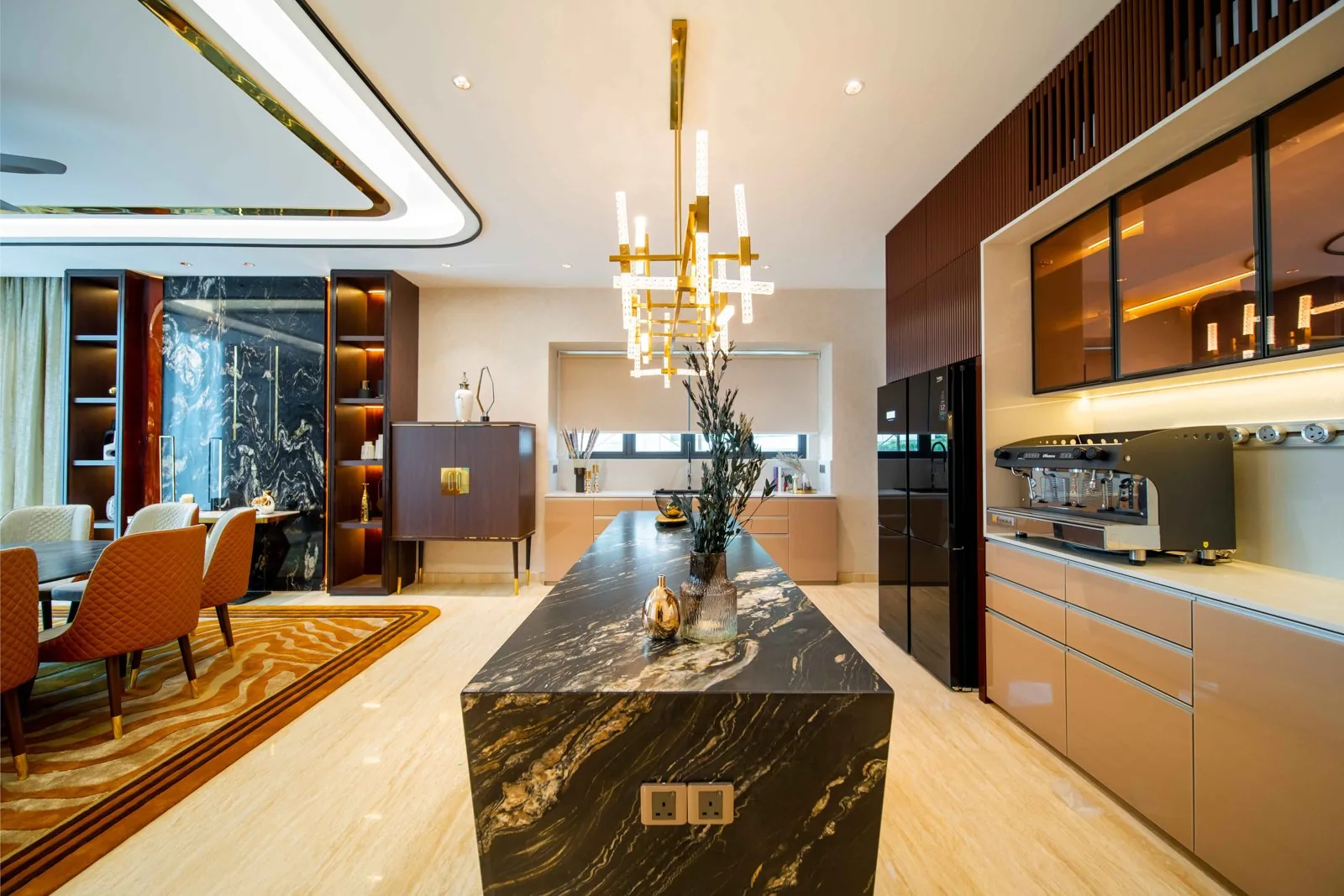 Curved tray ceiling and brass chandelier over the kitchen island in the Bangsar bungalow