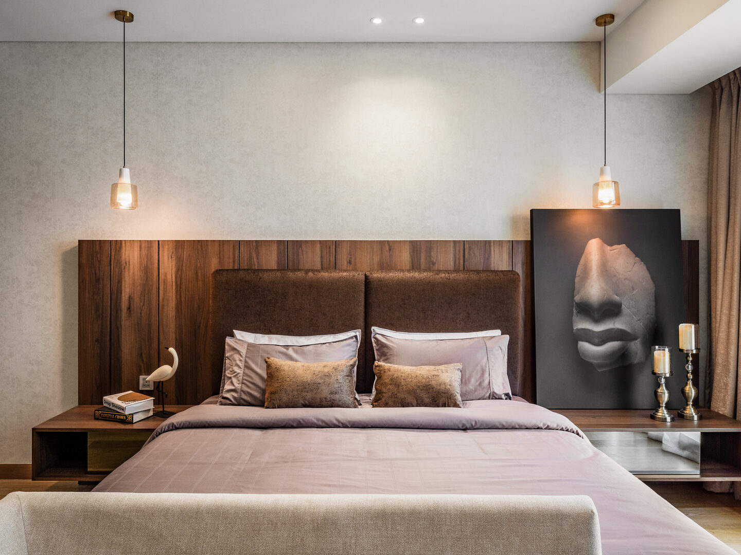 Condo master bedroom with pendant bedside lighting and a timber feature wall