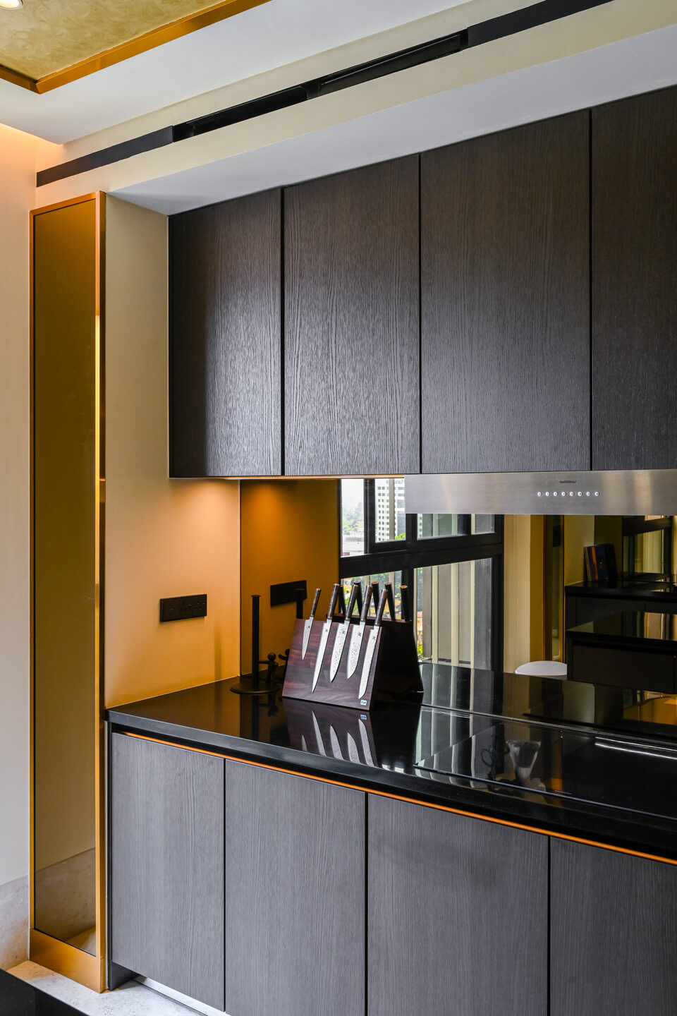 Dark timber kitchen cabinets in a Kuala Lumpur condominium