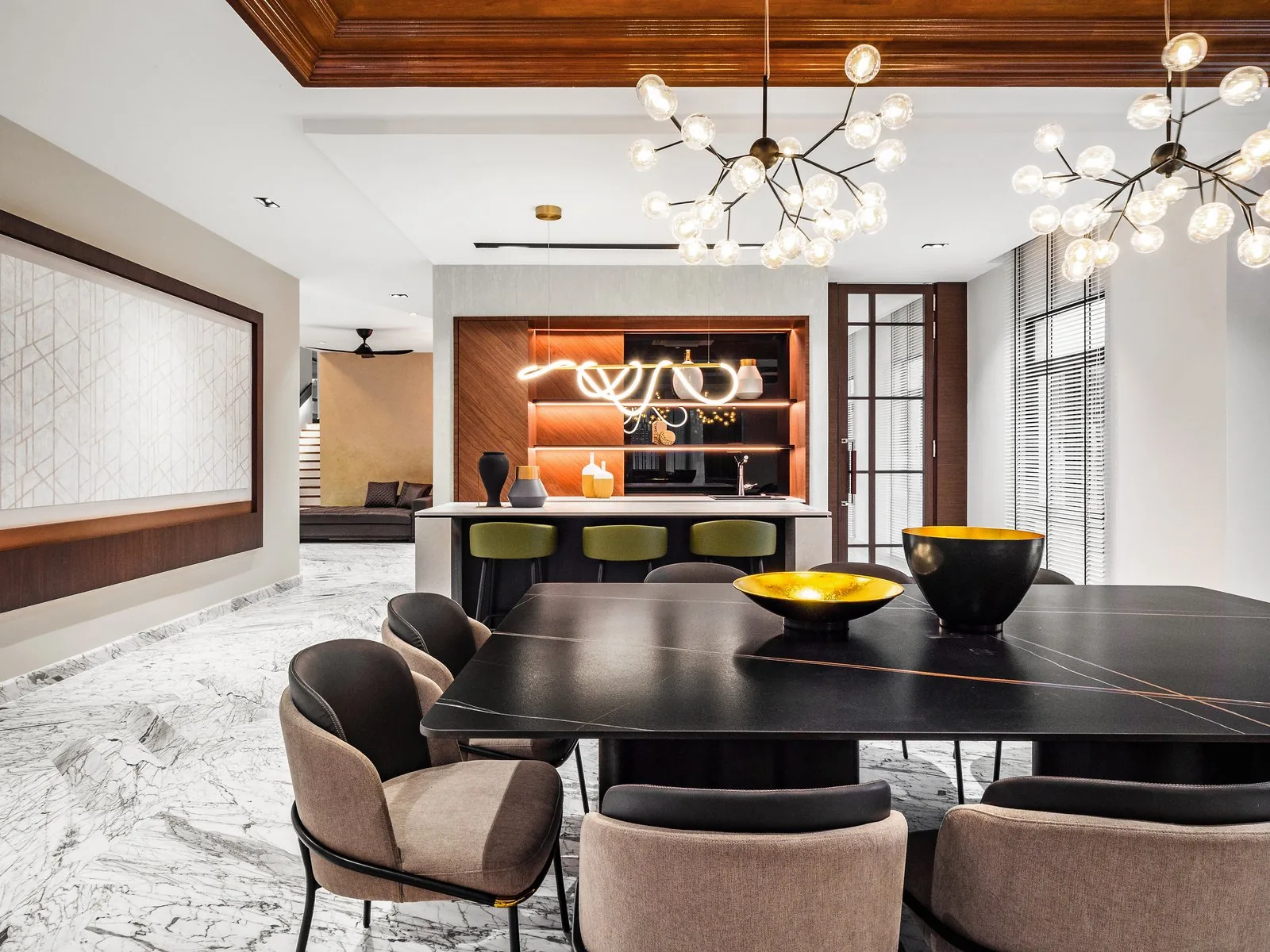 Dining room with a dark table, branch pendant lights and a coffered timber ceiling in an East Coast bungalow in Terengganu