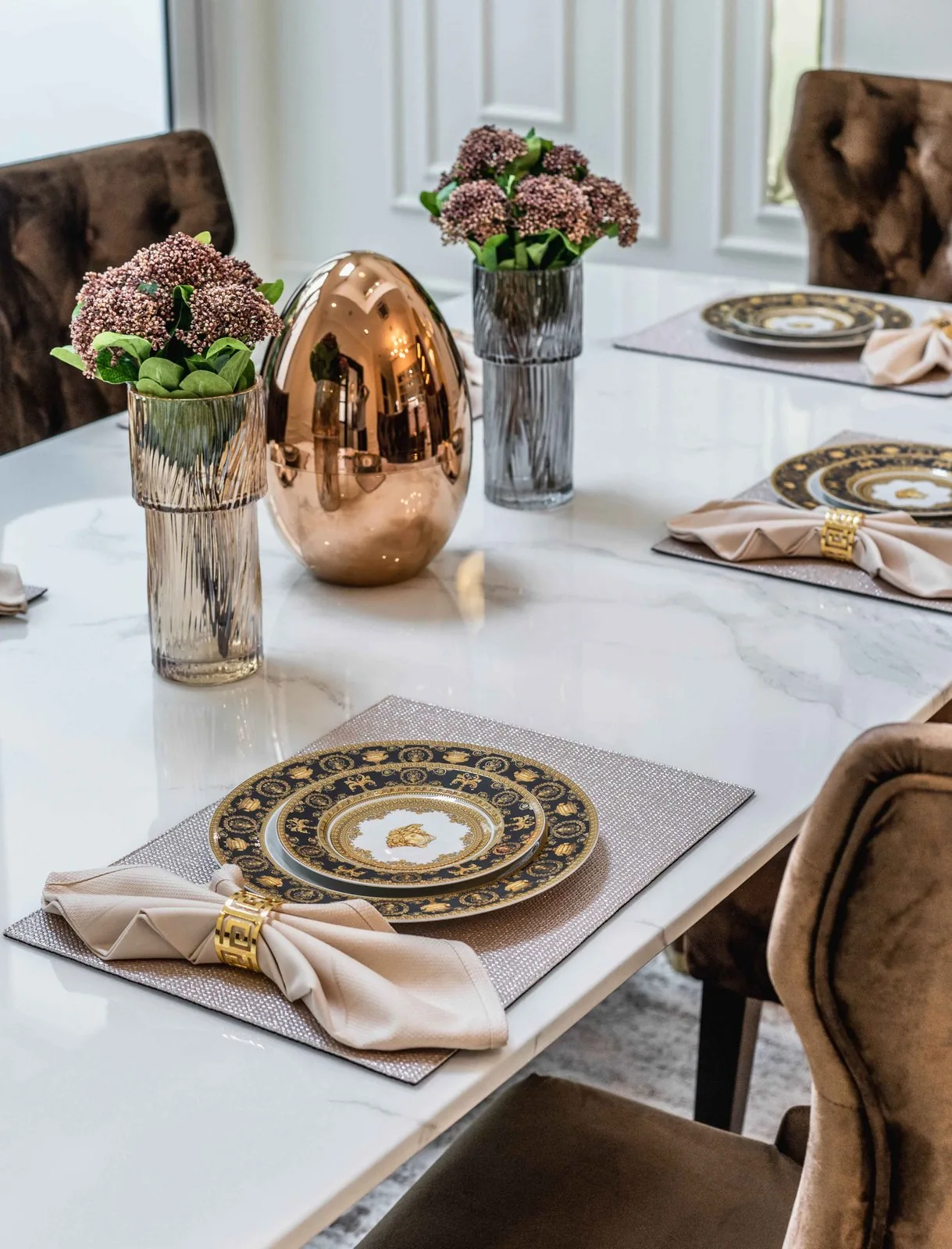 Dining table set with gold-rimmed plates and fresh flowers in a Johor Bahru landed home