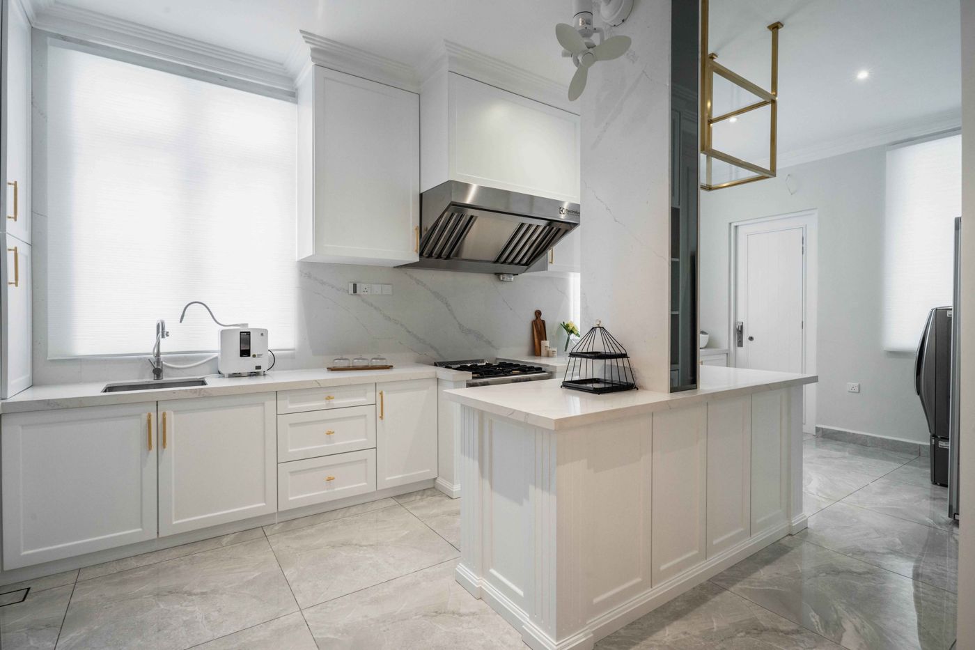 Kitchen with marble island in a double storey Malaysian home