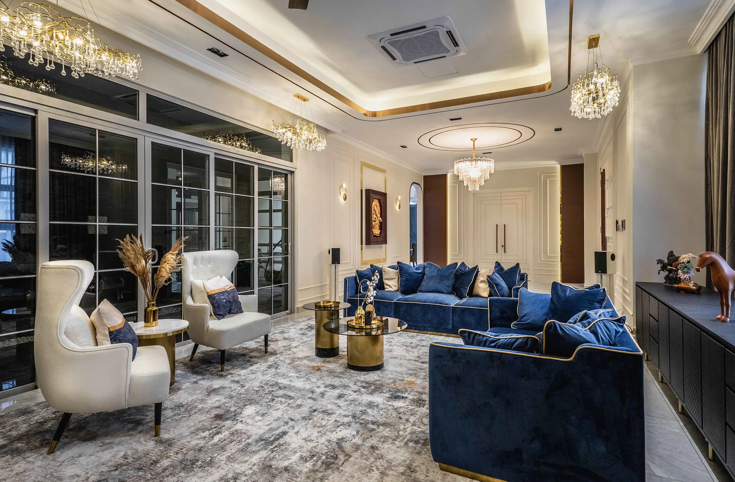 Transitional interior design in a Malaysian home — classic wingback seating and velvet sofas in a contemporary living room, EcoSpring