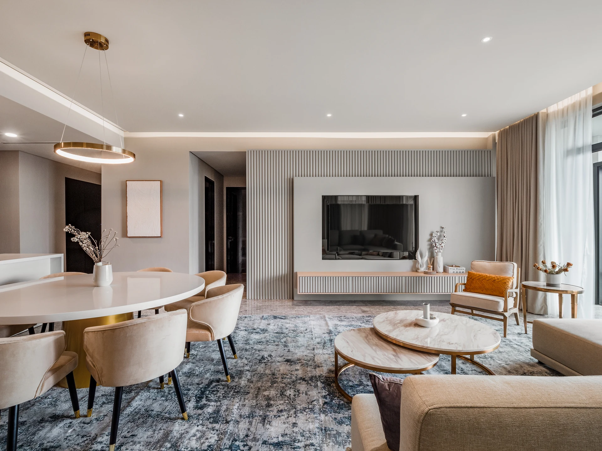 Fluted panel media wall with concealed television in a living hall at Four Seasons Residences, KLCC.