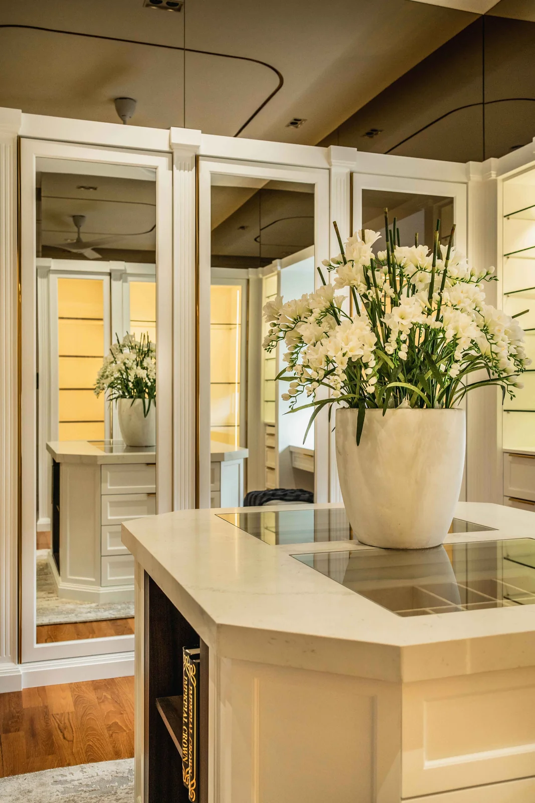 Glass display cabinet and island detail in a walk in wardrobe by Blaine Robert Design