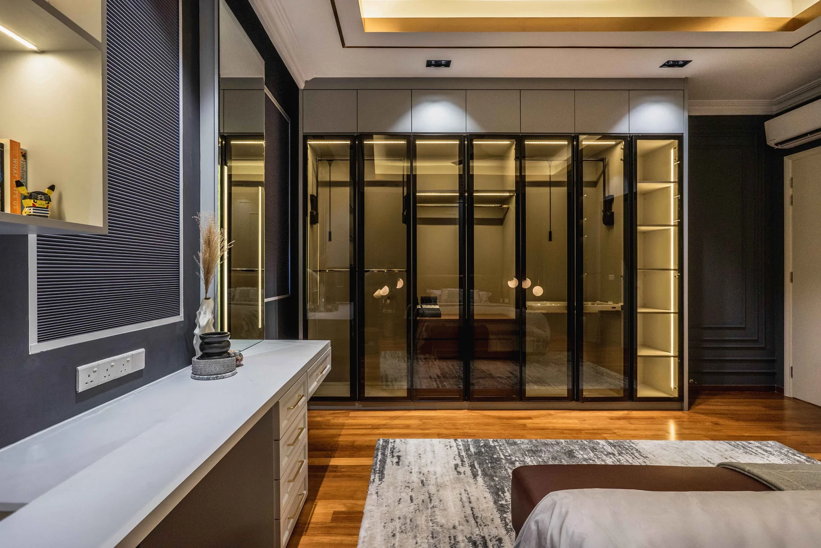 Glass-fronted floor to ceiling wardrobe wall in a master bedroom, Eco Spring bungalow