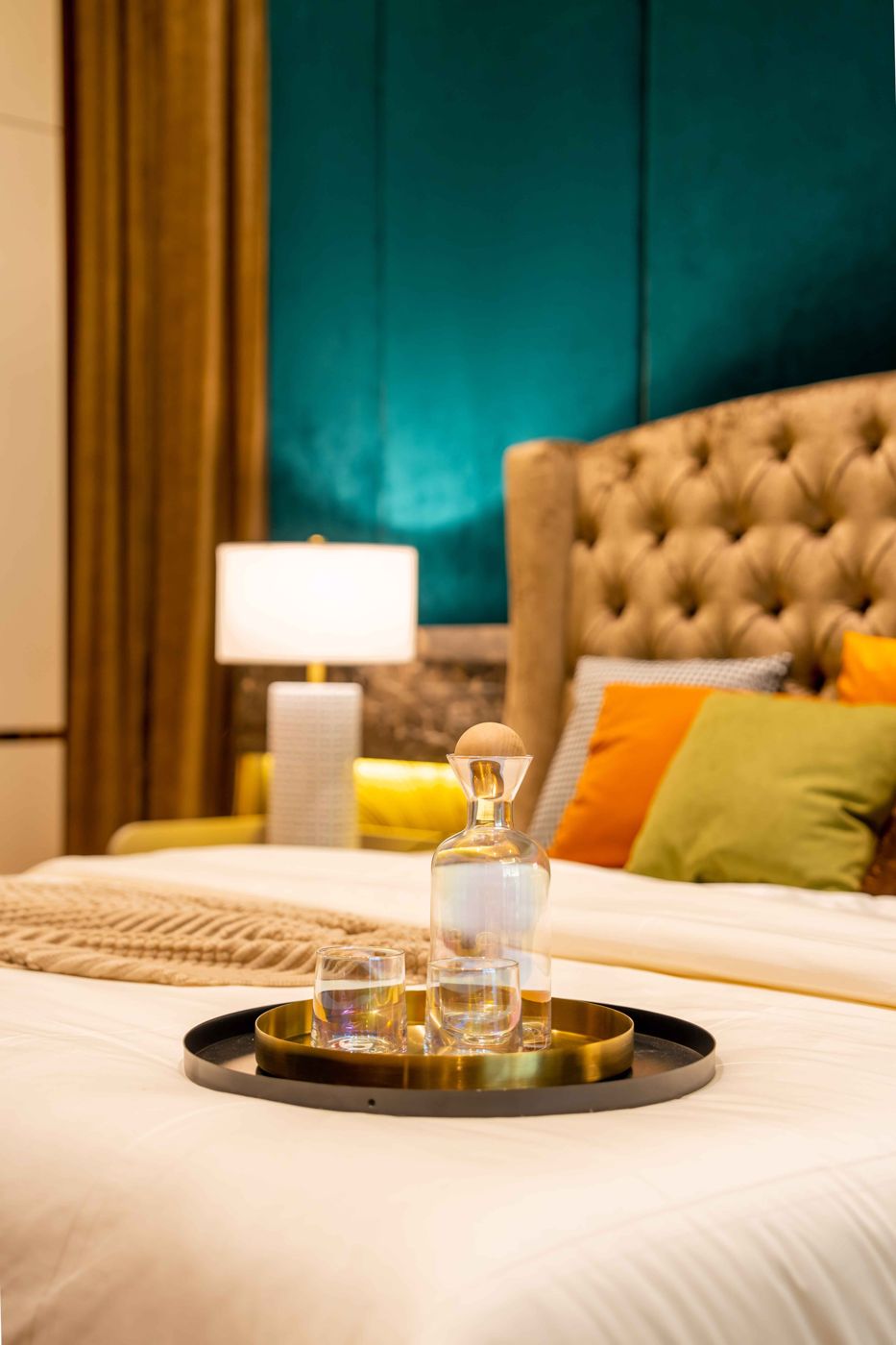 Bedside detail with teal feature wall in a Bangsar bungalow
