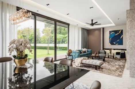 Living hall opening to the dining area under a crystal chandelier in a Kelana Jaya bungalow.