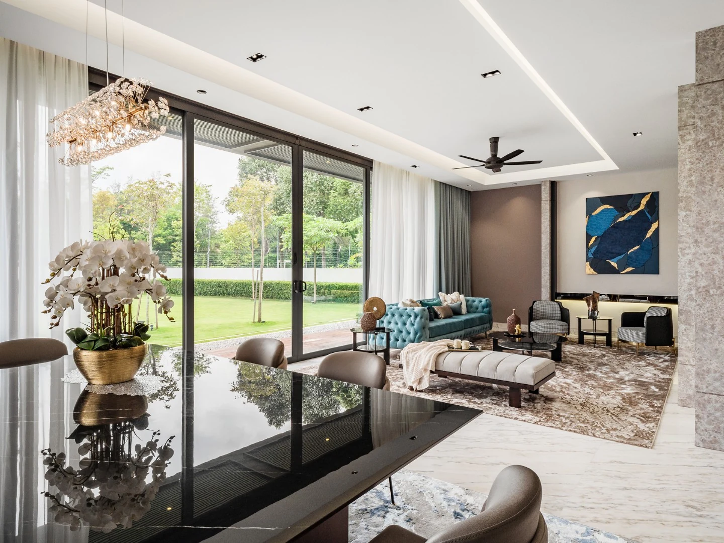 Living hall opening to the dining area under a crystal chandelier in a Kelana Jaya bungalow.