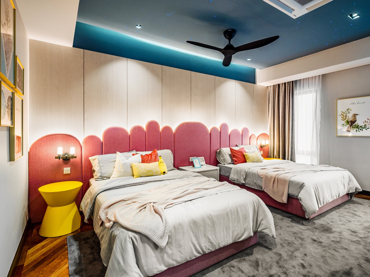 Kids bedroom with pink scalloped feature wall and navy ceiling in a Malaysian bungalow