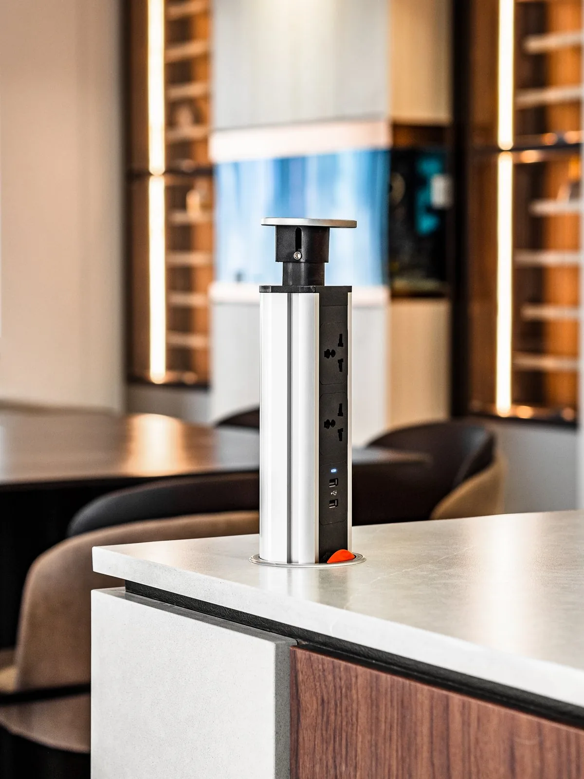 Pop-up power socket rising from a kitchen island worktop in a Terengganu bungalow