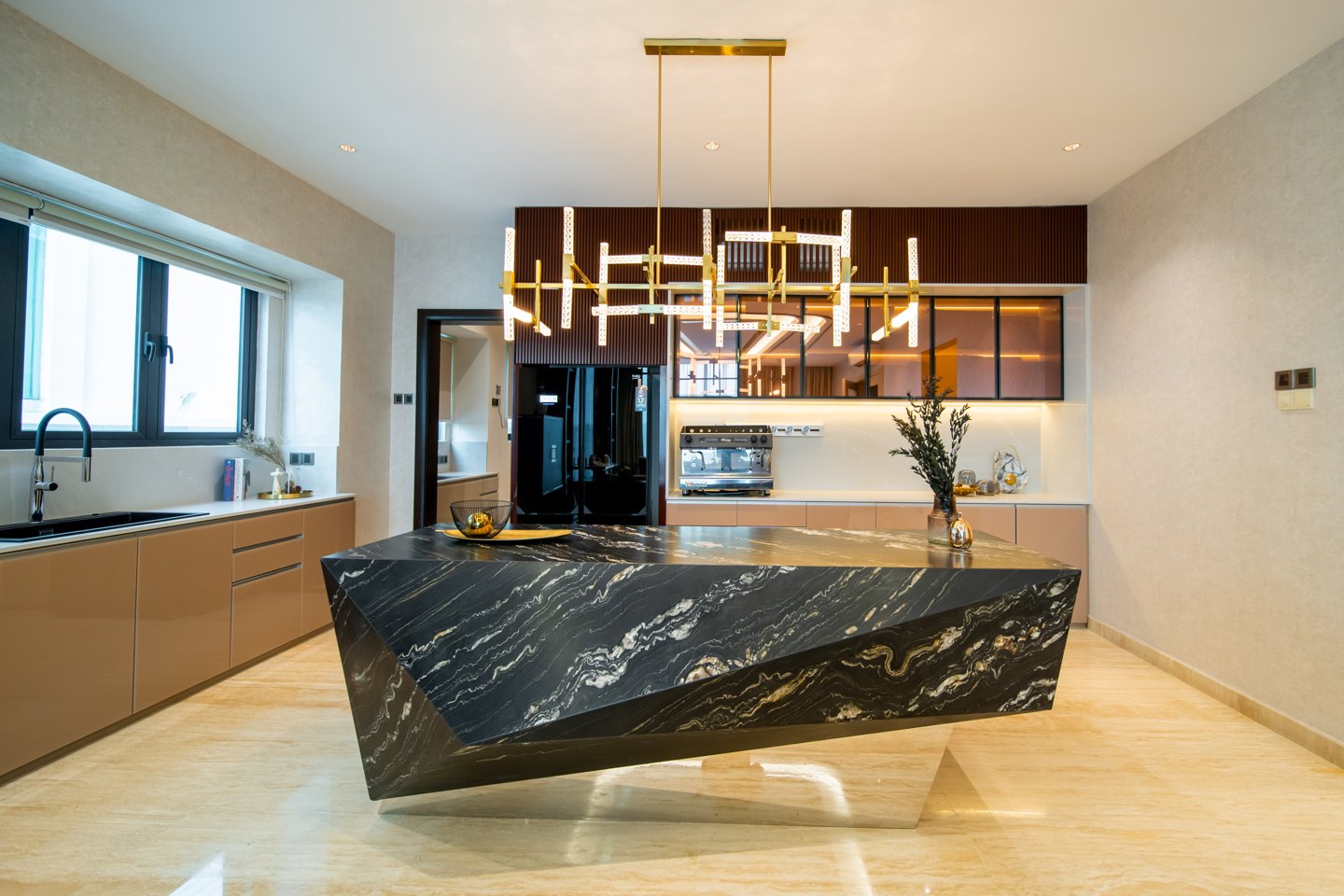 Kitchen design in Malaysia — black marble waterfall island under a linear brass pendant in the open-plan kitchen of a Bangsar bungalow, designed and built by Blaine Robert Design