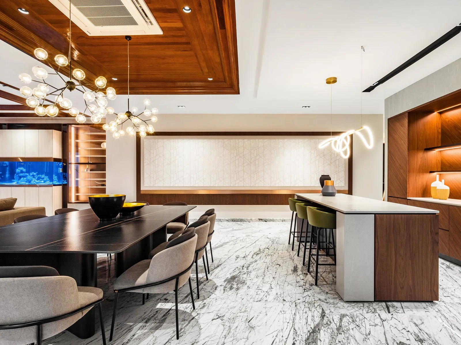 Kitchen island beside a long dining table in an open plan space at East Coast Villa, Terengganu
