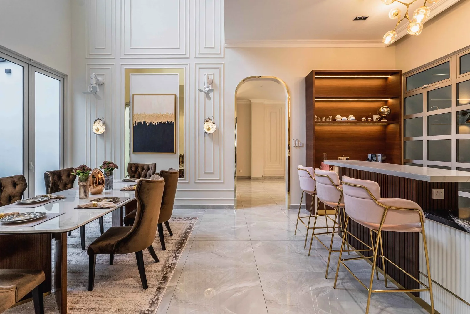 Kitchen island with pink bar stools next to the dining table at EcoSpring Villa, Johor Bahru