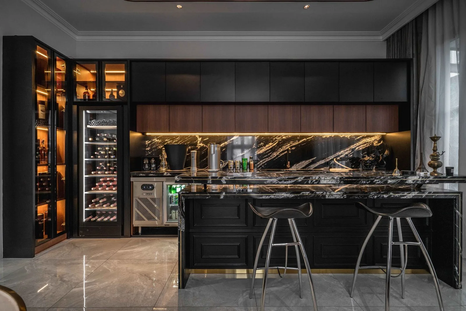 Black marble kitchen island with steel bar stools and wine storage at EcoSpring Villa