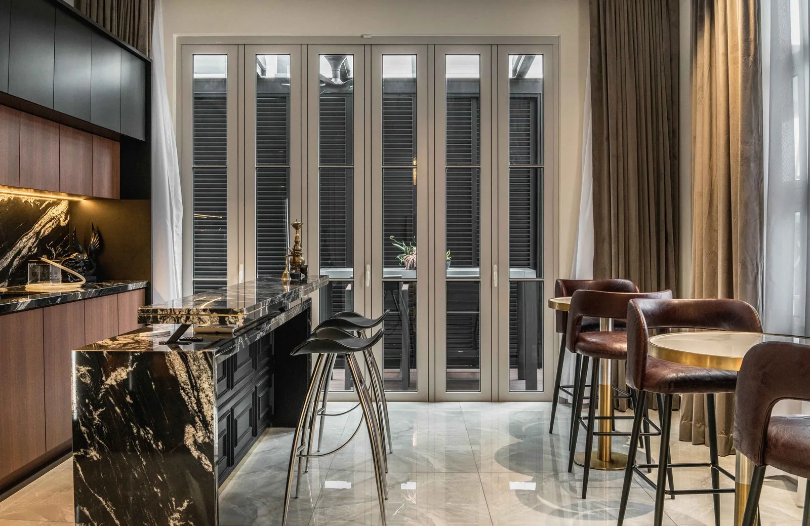Black marble waterfall island end with bar stools at EcoSpring Villa, Johor Bahru