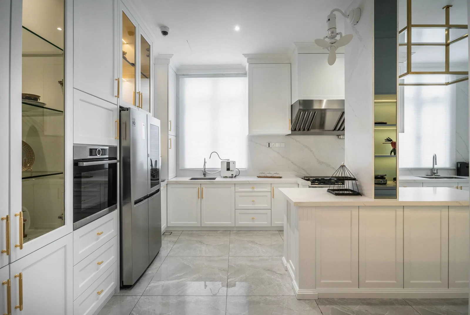 White Shaker kitchen island and cabinets with a stone countertop at EcoSpring Villa