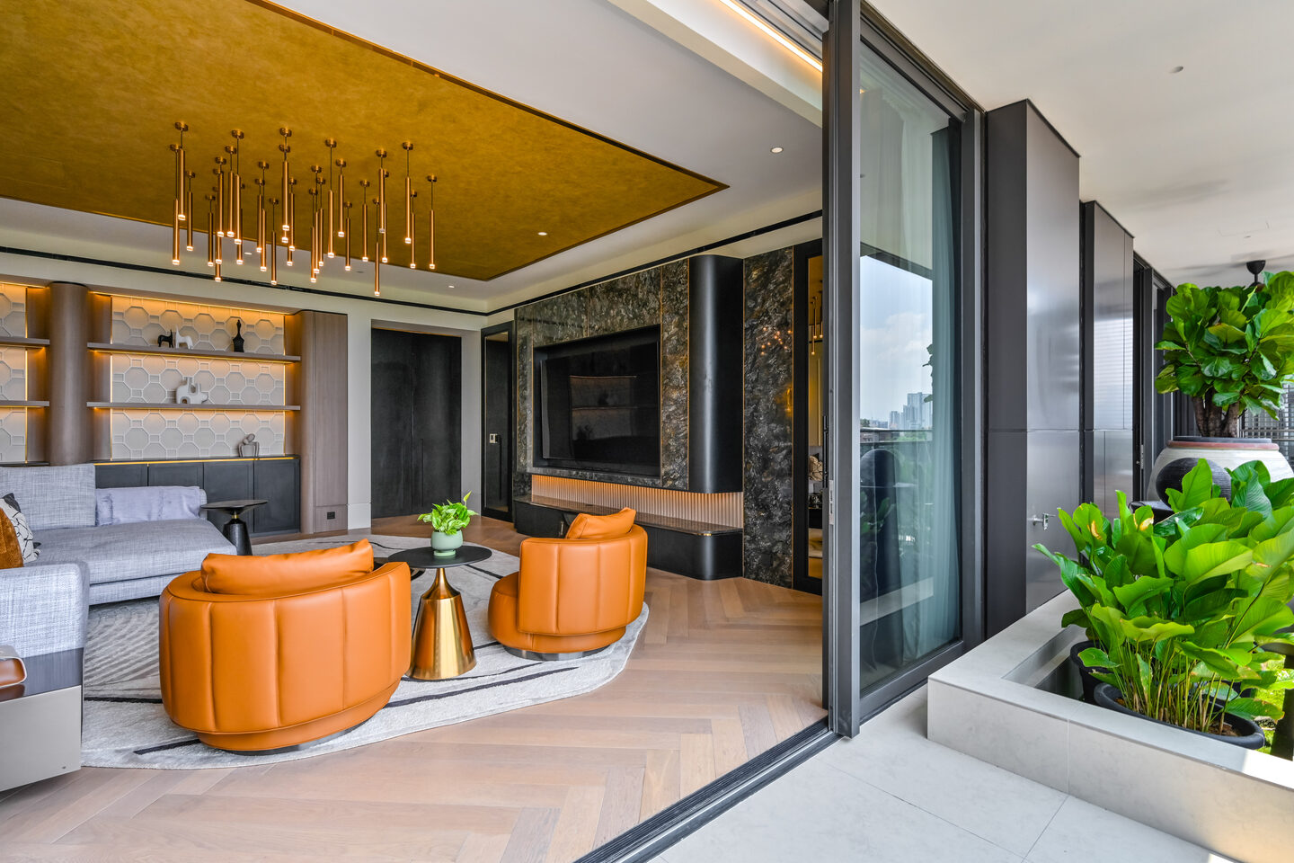 Open condo living area flowing to a planted balcony in a KL high-rise