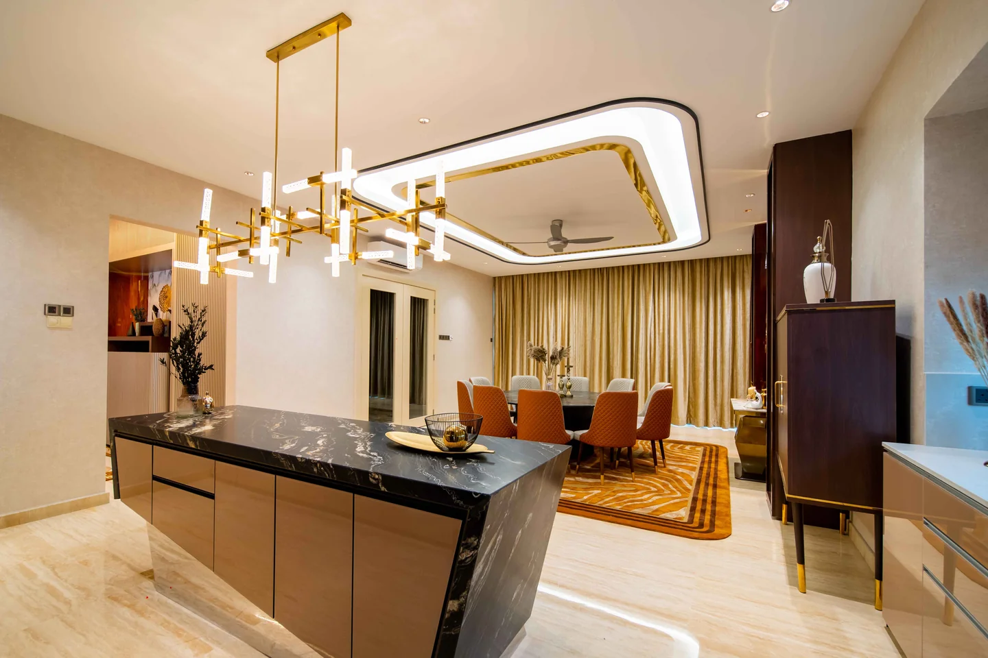 Clear pathway running past a black marble kitchen island to the dining table and living area, Bangsar Bukit Pantai bungalow