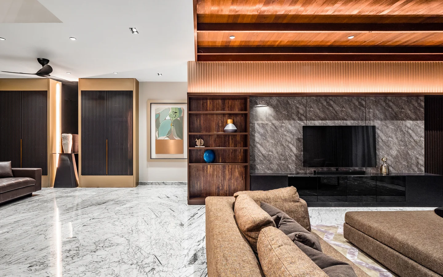 Sectional sofa with round coffee tables and a low TV console below a timber ceiling, Malaysian bungalow living room