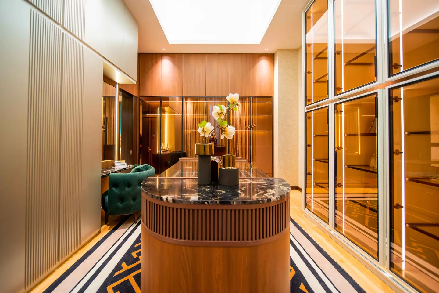 Layered lighting: backlit display shelving, mirrored panels and downlights in a lounge, Bangsar Bukit Pantai bungalow