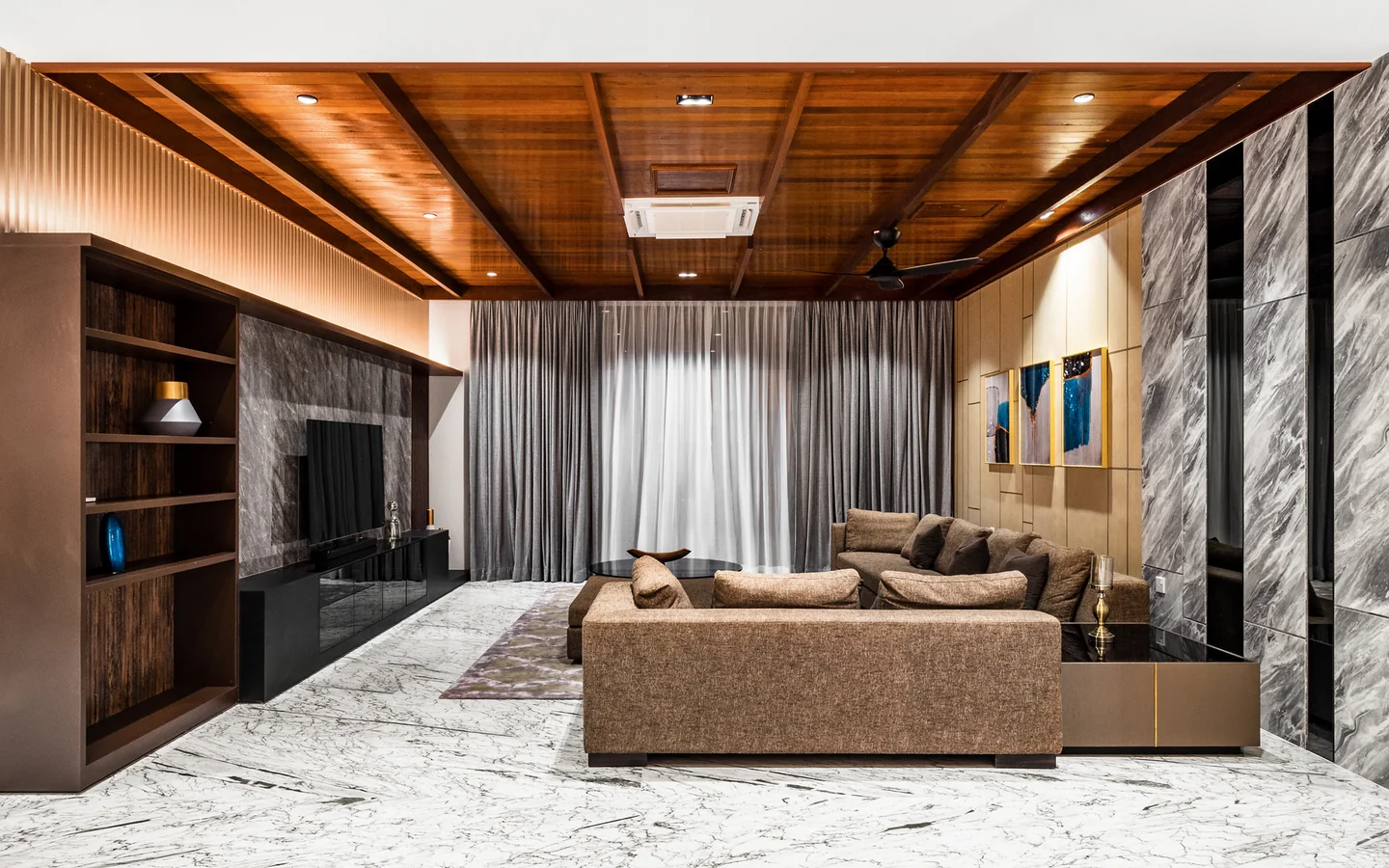 Large brown sectional sofa scaled to a double-height living room with timber-clad ceiling and marble floor, Malaysian bungalow